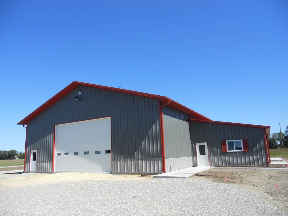 Gray metal building with red trim