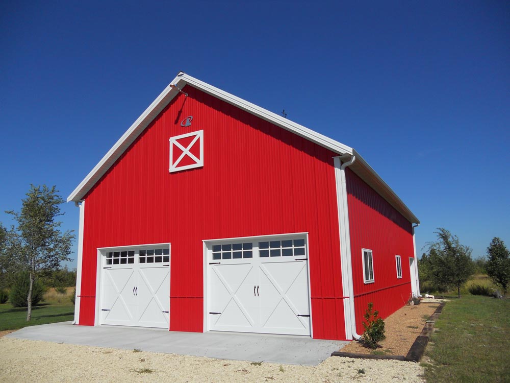 Red metal barn with 2 garage bays