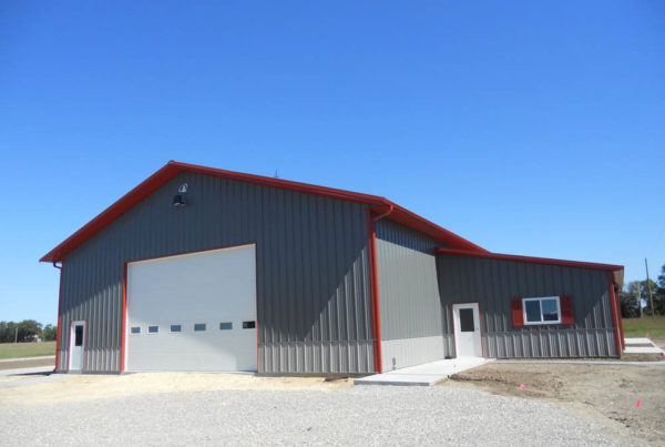 Gray metal building with red trim